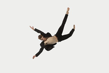 Image showing Man in casual style clothes jumping and dancing isolated on white background. Art, motion, action, flexibility, inspiration concept. Flexible caucasian ballet dancer.