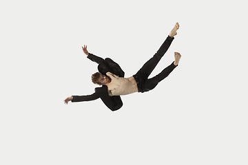 Image showing Man in casual style clothes jumping and dancing isolated on white background. Art, motion, action, flexibility, inspiration concept. Flexible caucasian ballet dancer.