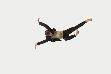 Image showing Man in casual style clothes jumping and dancing isolated on white background. Art, motion, action, flexibility, inspiration concept. Flexible caucasian ballet dancer.