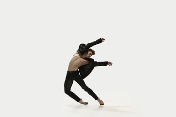 Image showing Man in casual style clothes jumping and dancing isolated on white background. Art, motion, action, flexibility, inspiration concept. Flexible caucasian ballet dancer.