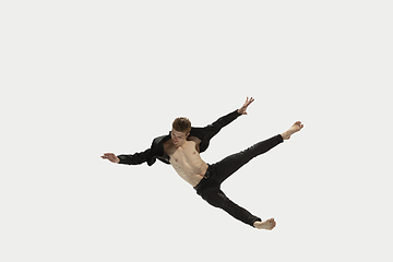 Image showing Man in casual style clothes jumping and dancing isolated on white background. Art, motion, action, flexibility, inspiration concept. Flexible caucasian ballet dancer.