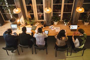 Image showing Colleagues working together in modern office using devices and gadgets during creative meeting