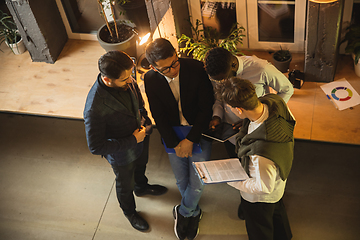 Image showing Colleagues working together in modern office using devices and gadgets during creative meeting