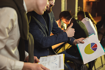 Image showing Colleagues working together in modern office using devices and gadgets during creative meeting