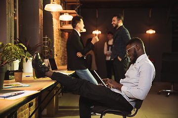 Image showing Colleagues working together in modern office using devices and gadgets during creative meeting