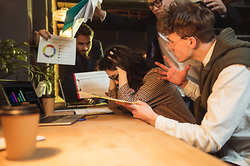 Image showing Colleagues working together in modern office using devices and gadgets during creative meeting