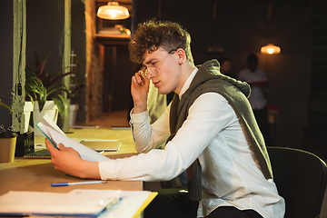 Image showing Young man working together in modern office using devices and gadgets during creative meeting