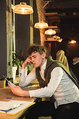 Image showing Young man working together in modern office using devices and gadgets during creative meeting