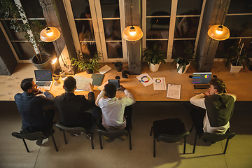 Image showing Colleagues working together in modern office using devices and gadgets during creative meeting