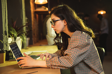 Image showing Young woman working together in modern office using devices and gadgets during creative meeting