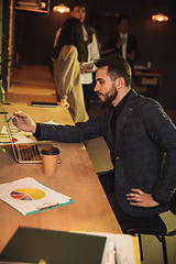 Image showing Colleagues working together in modern office using devices and gadgets during creative meeting