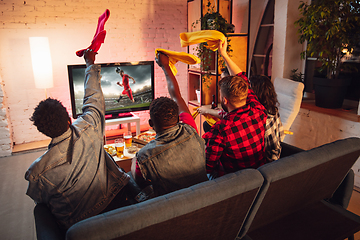 Image showing Group of friends watching TV, sport match together. Emotional fans cheering for favourite team, watching on exciting game. Concept of friendship, leisure activity, emotions