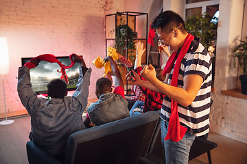 Image showing Group of friends watching TV, sport match together. Emotional man cheering for favourite team, celebrating successful betting. Concept of friendship, leisure activity, emotions