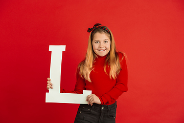 Image showing Valentine\'s day celebration, happy caucasian girl holding letter on red background