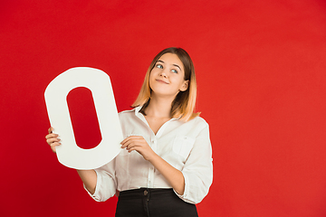 Image showing Valentine\'s day celebration, happy caucasian girl holding letter on red background