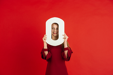 Image showing Valentine\'s day celebration, happy caucasian girl holding letter on red background