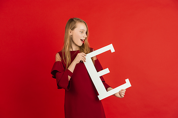 Image showing Valentine\'s day celebration, happy caucasian girl holding letter on red background