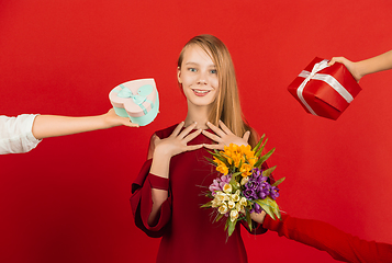 Image showing Valentine\'s day celebration, happy caucasian girl isolated on red background