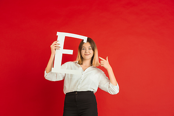 Image showing Valentine\'s day celebration, happy caucasian girl holding letter on red background