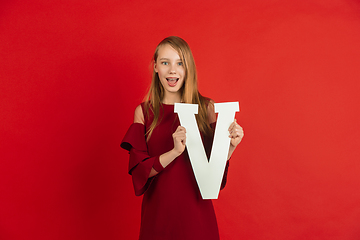 Image showing Valentine\'s day celebration, happy caucasian girl holding letter on red background