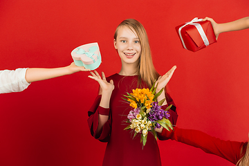 Image showing Valentine\'s day celebration, happy caucasian girl isolated on red background