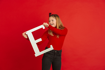 Image showing Valentine\'s day celebration, happy caucasian girl holding letter on red background