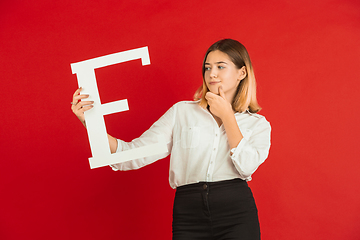 Image showing Valentine\'s day celebration, happy caucasian girl holding letter on red background