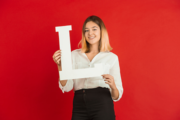 Image showing Valentine\'s day celebration, happy caucasian girl holding letter on red background