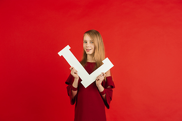 Image showing Valentine\'s day celebration, happy caucasian girl holding letter on red background