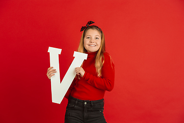 Image showing Valentine\'s day celebration, happy caucasian girl holding letter on red background