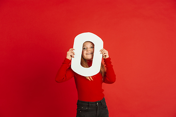 Image showing Valentine\'s day celebration, happy caucasian girl holding letter on red background