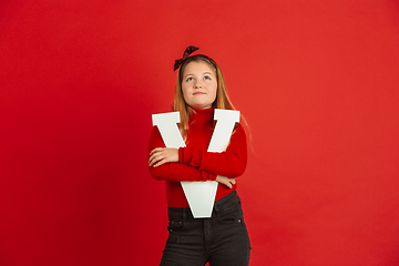 Image showing Valentine\'s day celebration, happy caucasian girl holding letter on red background