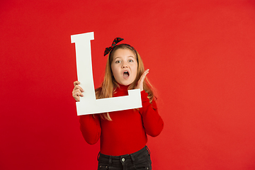 Image showing Valentine\'s day celebration, happy caucasian girl holding letter on red background