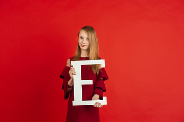 Image showing Valentine\'s day celebration, happy caucasian girl holding letter on red background