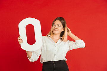 Image showing Valentine\'s day celebration, happy caucasian girl holding letter on red background