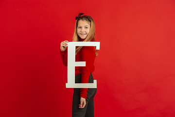 Image showing Valentine\'s day celebration, happy caucasian girl holding letter on red background