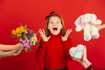 Image showing Valentine\'s day celebration, happy caucasian girl isolated on red background