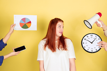 Image showing Caucasian young woman\'s portrait on yellow background, too much tasks