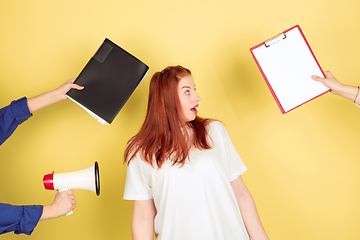 Image showing Caucasian young woman\'s portrait on yellow background, too much tasks