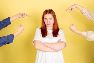 Image showing Caucasian young woman\'s portrait on yellow background, too much tasks