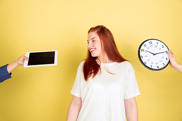 Image showing Caucasian young woman\'s portrait on yellow background, too much tasks