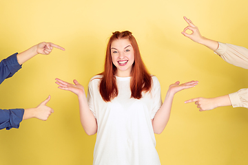 Image showing Caucasian young woman\'s portrait on yellow background, too much tasks