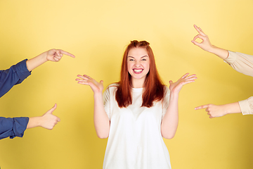 Image showing Caucasian young woman\'s portrait on yellow background, too much tasks