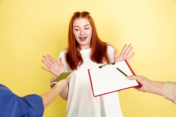 Image showing Caucasian young woman\'s portrait on yellow background, too much tasks