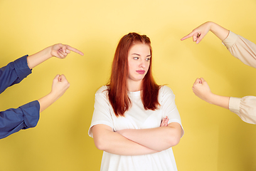 Image showing Caucasian young woman\'s portrait on yellow background, too much tasks