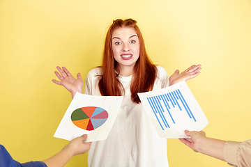 Image showing Caucasian young woman\'s portrait on yellow background, too much tasks