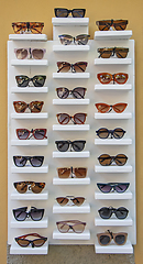 Image showing A lot of sunglasses for sale on the stand in the street