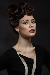 Image showing beautiful young woman with fancy hairdo and red lips