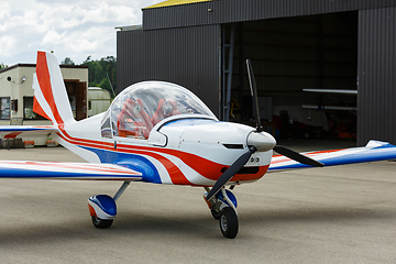 Image showing outdoor shot of small plane standing in shed