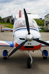 Image showing outdoor shot of small plane standing in shed